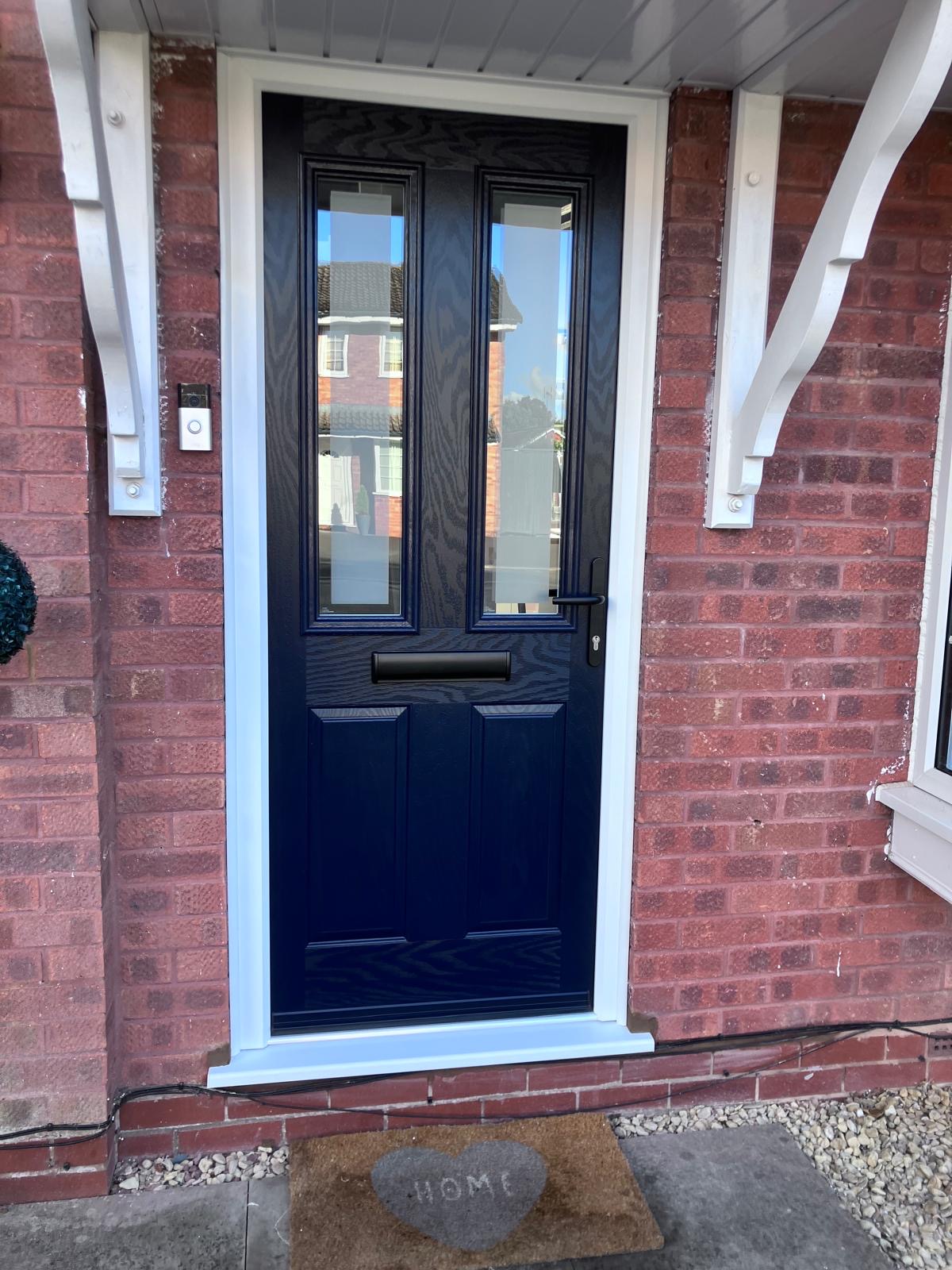 Deep navy front door with twin glazed panels