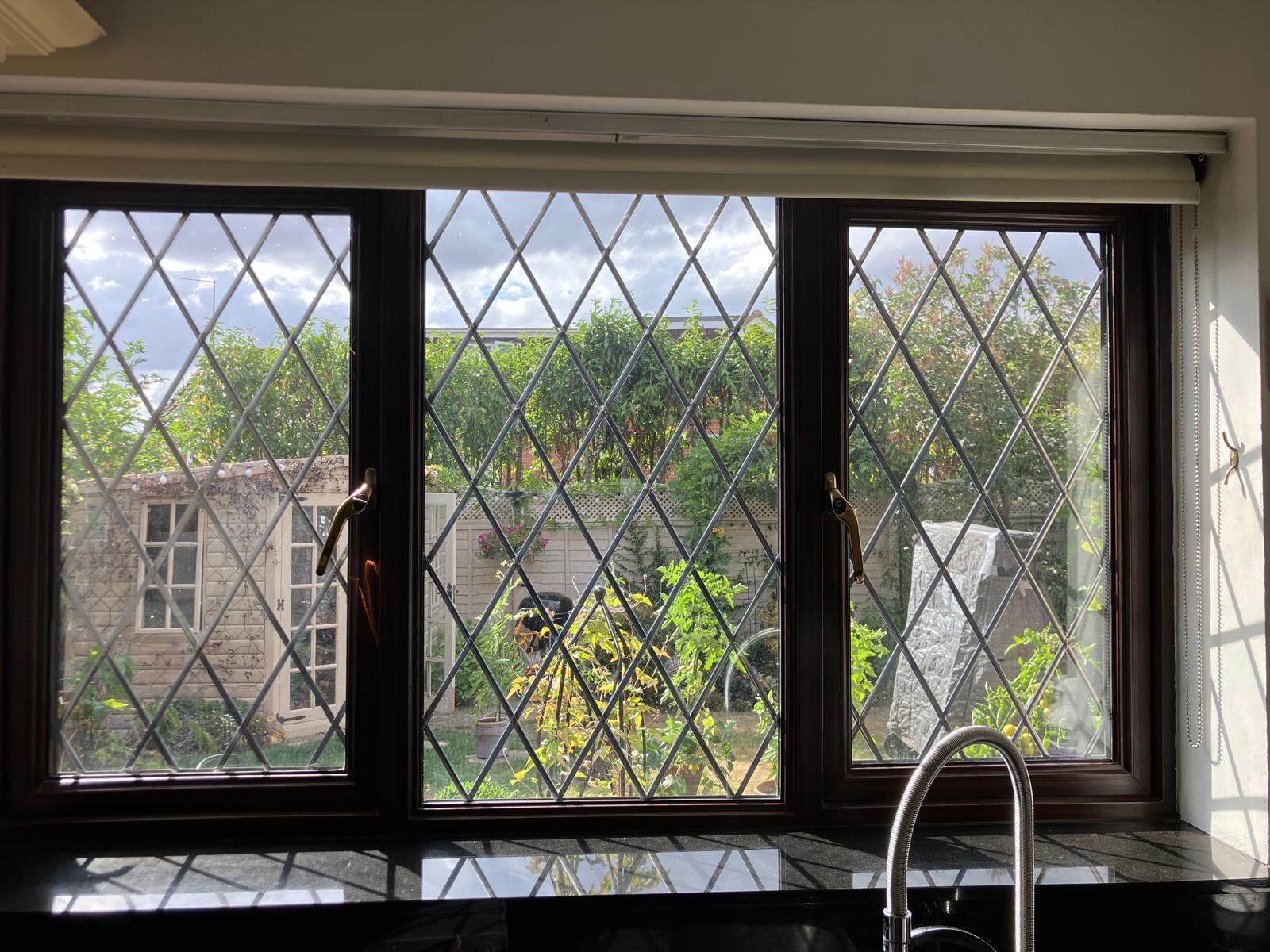 Repaired leaded kitchen window overlooking a garden